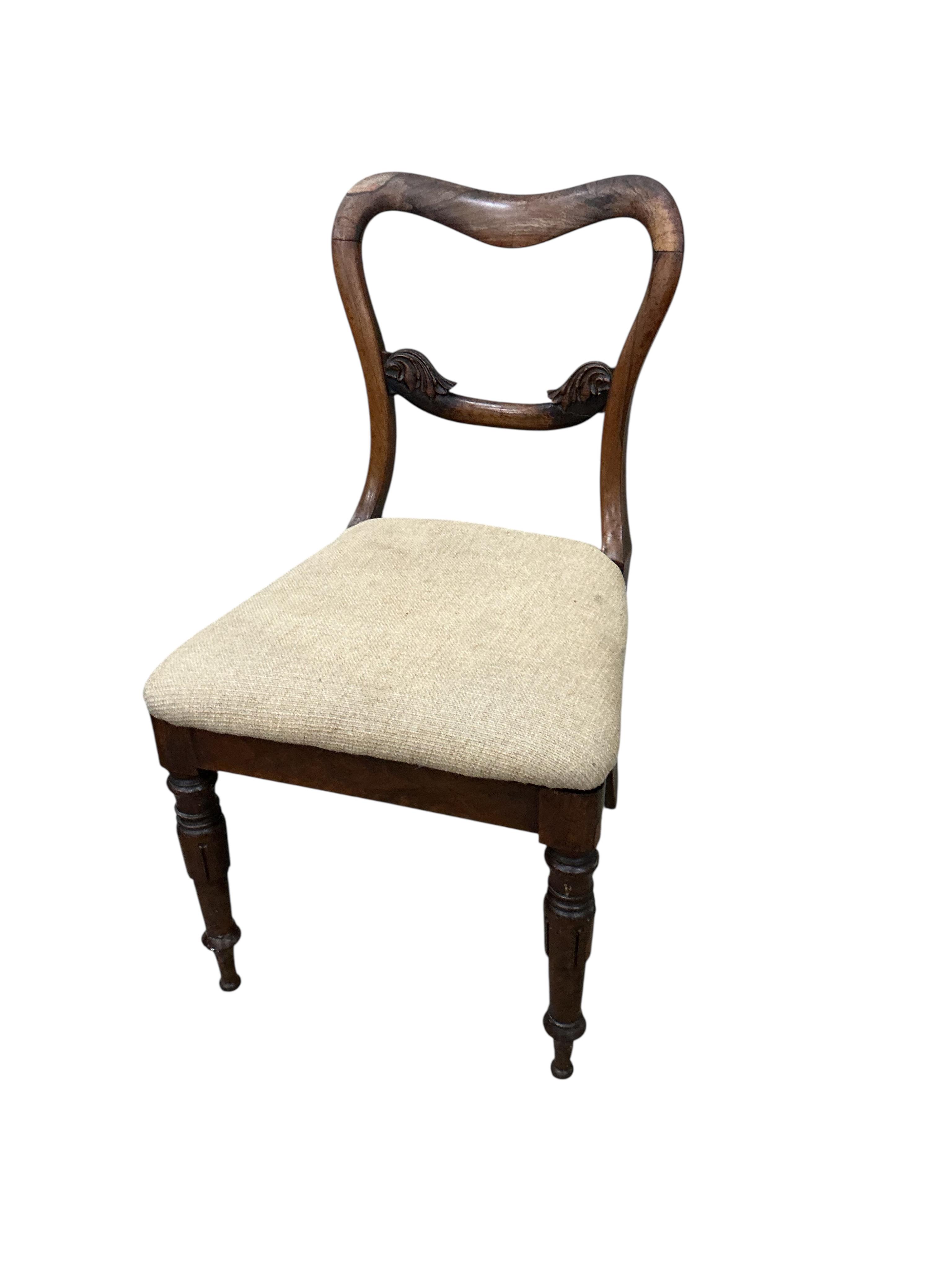 A set of four early Victorian rosewood dining chairs with drop in seats